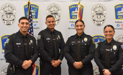 Four newly sworn in Coral Gables police officers standing side by side